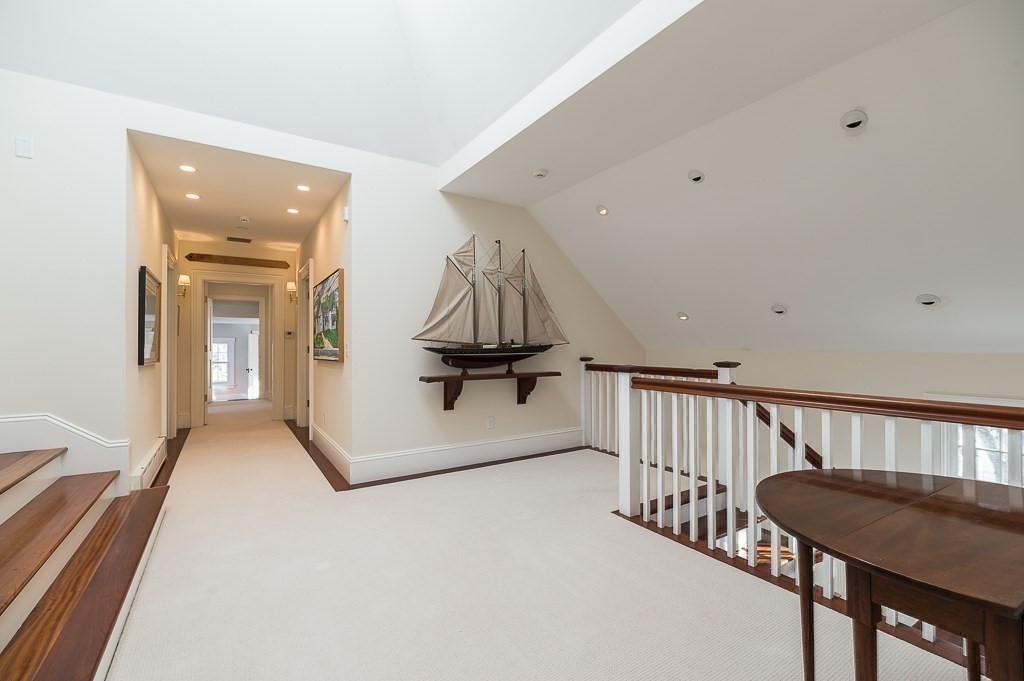 13 Main Street Boxford, MA 01921 - Photo 24 of 36 a view of a hallway with couches and a potted plant on a table