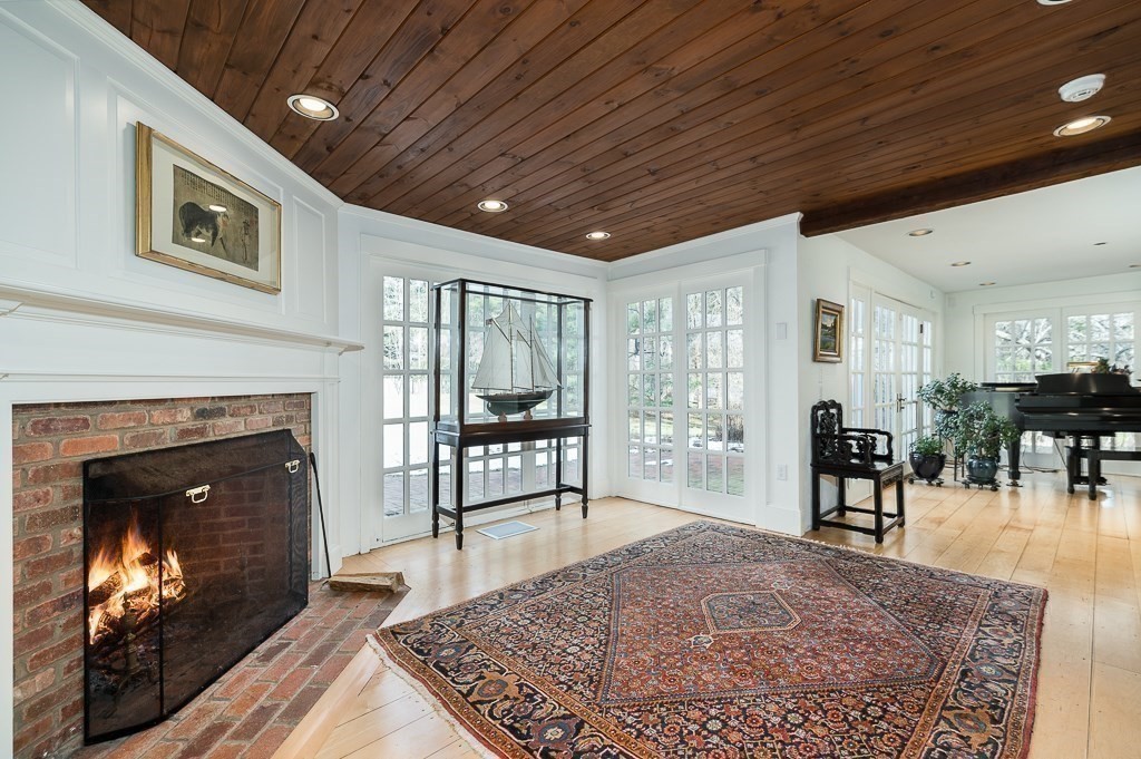 13 Main Street Boxford, MA 01921 - Photo 3 of 36 a living room with furniture a fireplace and a table