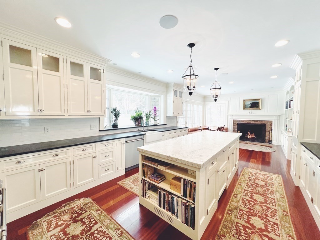 13 Main Street Boxford, MA 01921 - Photo 8 of 36 a open kitchen with stainless steel appliances granite countertop a stove top oven a sink dishwasher and a dining table with wooden floor