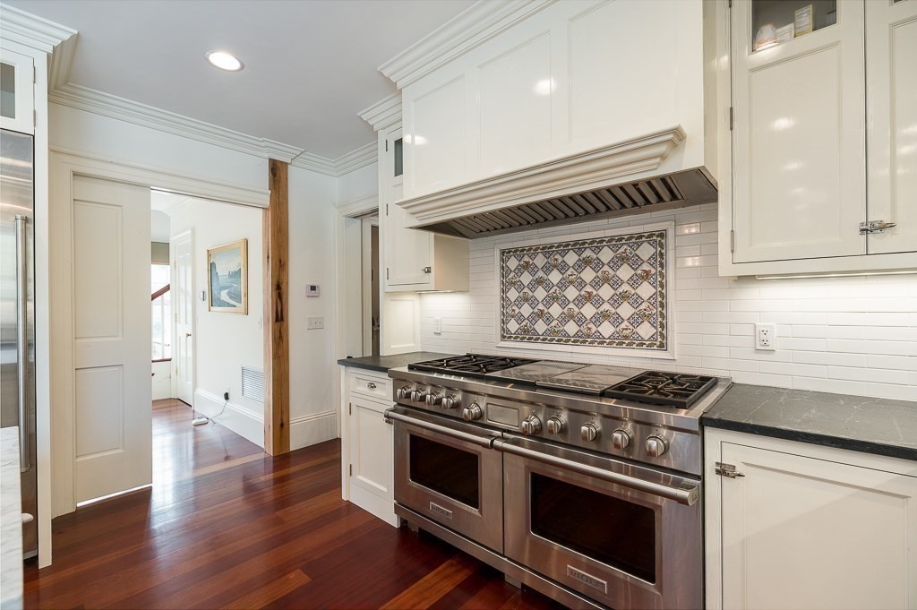 13 Main Street Boxford, MA 01921 - Photo 9 of 36 a kitchen with wooden floor and a stove top oven