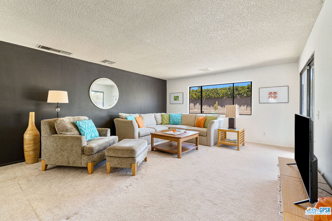 1250 East Delgado Road Palm Springs, CA 92262 - Photo 13 of 35 a living room with furniture and a flat screen tv