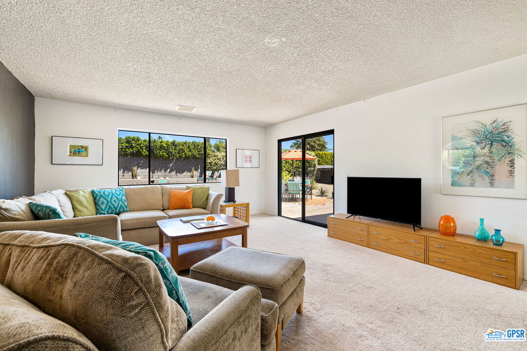 1250 East Delgado Road Palm Springs, CA 92262 - Photo 14 of 35 a living room with furniture and a flat screen tv