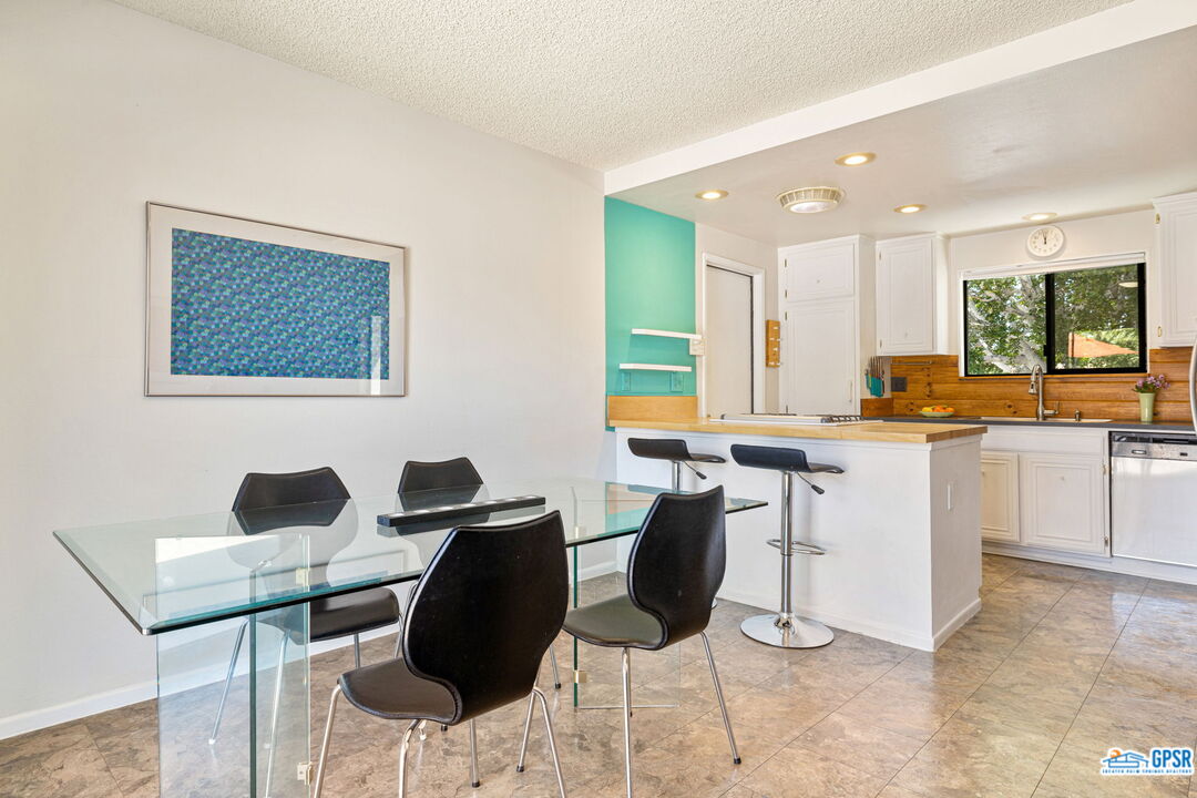 1250 East Delgado Road Palm Springs, CA 92262 - Photo 15 of 35 a kitchen with granite countertop cabinets and chairs