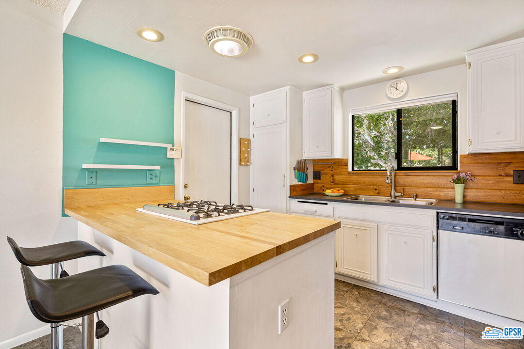 1250 East Delgado Road Palm Springs, CA 92262 - Photo 16 of 35 a kitchen with stainless steel appliances granite countertop a sink and a stove