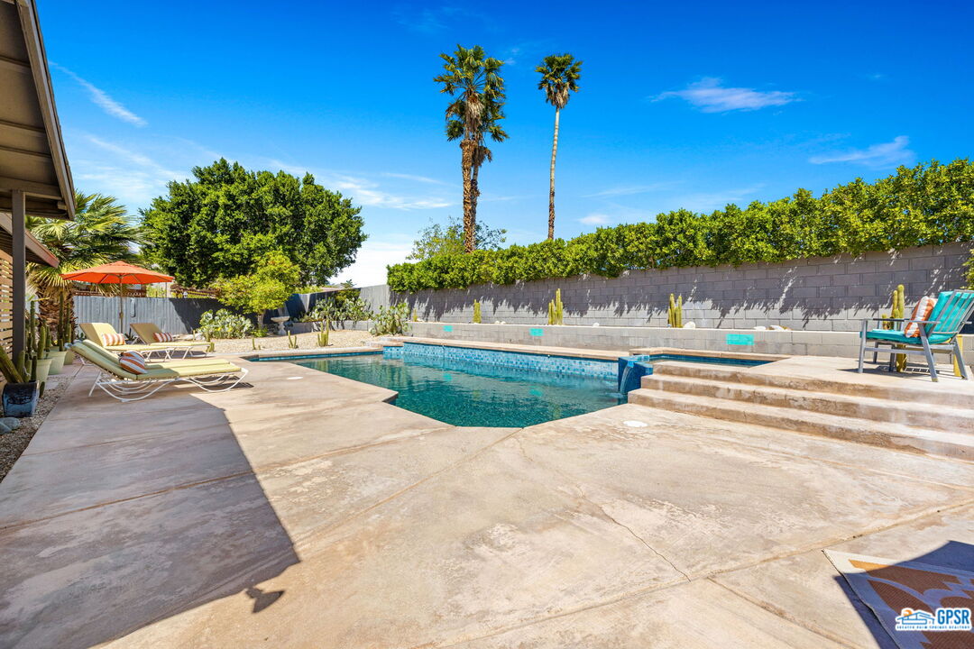 1250 East Delgado Road Palm Springs, CA 92262 - Photo 22 of 35 a view of a swimming pool with a yard