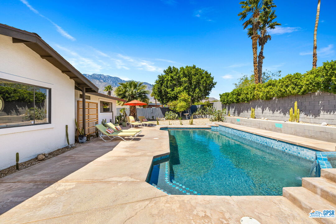 1250 East Delgado Road Palm Springs, CA 92262 - Photo 23 of 35 a swimming pool with outdoor seating and garden