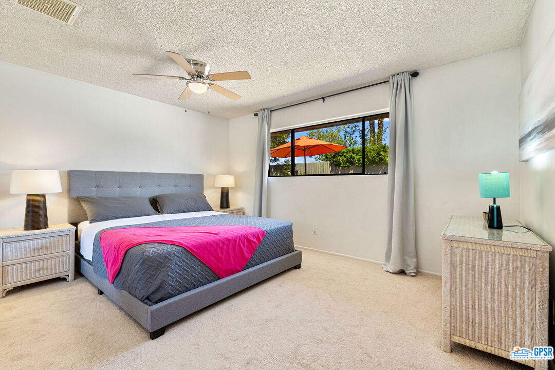 1250 East Delgado Road Palm Springs, CA 92262 - Photo 24 of 35 a bedroom with a bed and a flat screen tv