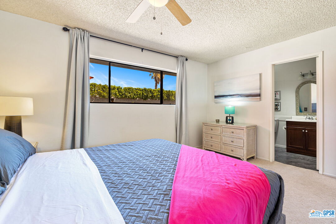 1250 East Delgado Road Palm Springs, CA 92262 - Photo 26 of 35 a bedroom with a bed and a view of kitchen