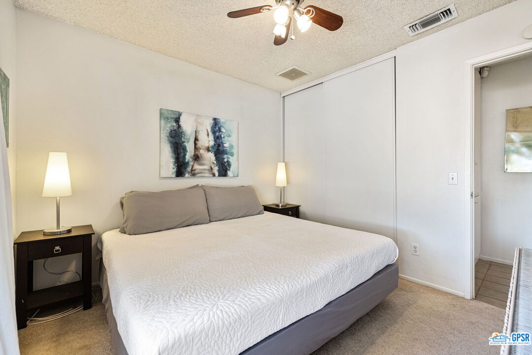 1250 East Delgado Road Palm Springs, CA 92262 - Photo 29 of 35 a bedroom with a bed and a chandelier