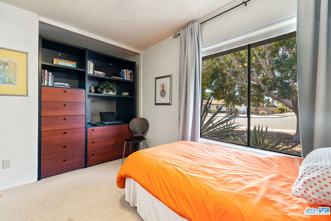 1250 East Delgado Road Palm Springs, CA 92262 - Photo 32 of 35 a bedroom with a bed dresser and a window