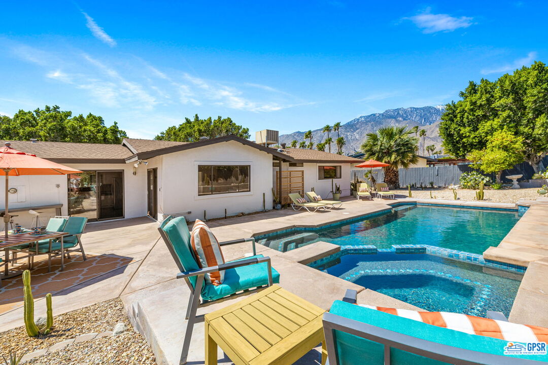 1250 East Delgado Road Palm Springs, CA 92262 - Photo 4 of 35 a view of a patio with couches table and chairs with wooden floor and fence