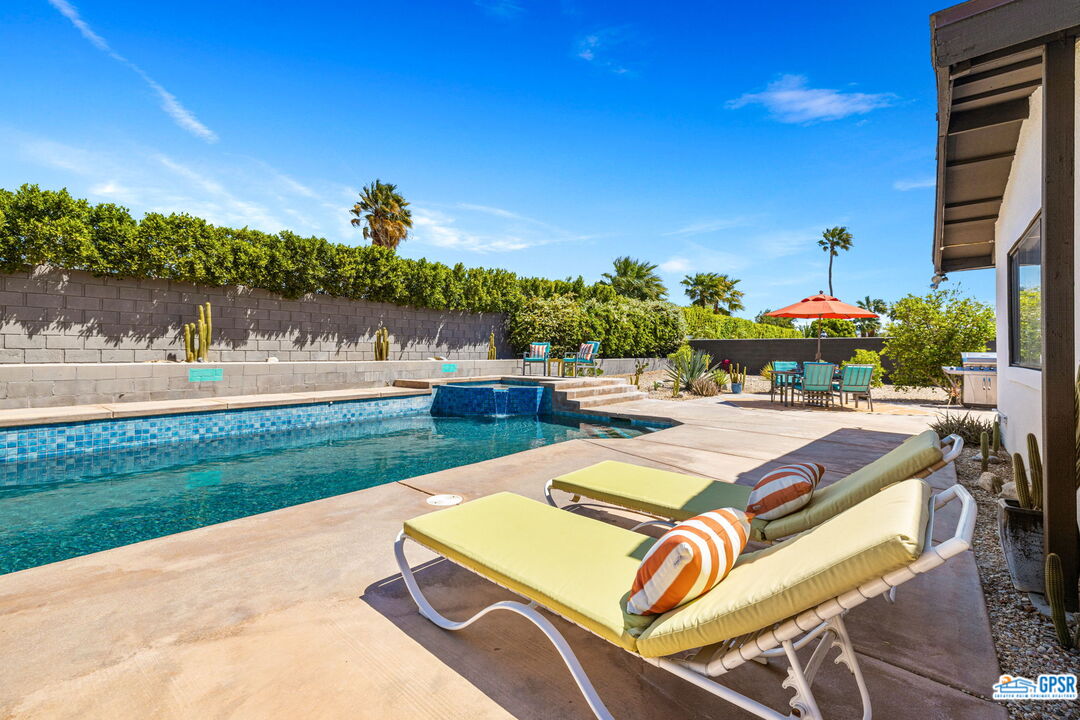 1250 East Delgado Road Palm Springs, CA 92262 - Photo 7 of 35 a view of swimming pool with outdoor seating and city view
