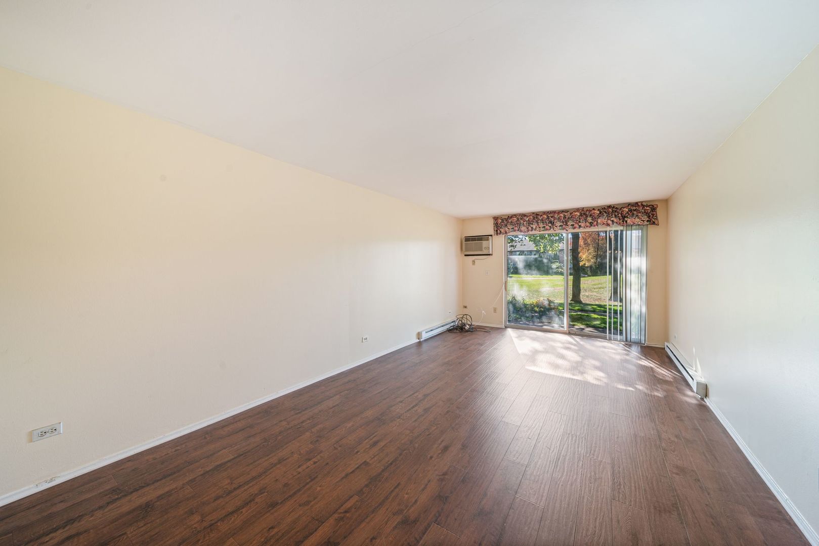 826 East Old Willow Road, Unit 103 Prospect Heights, IL 60070 - Photo 6 of 25 an empty room with wooden floor and windows