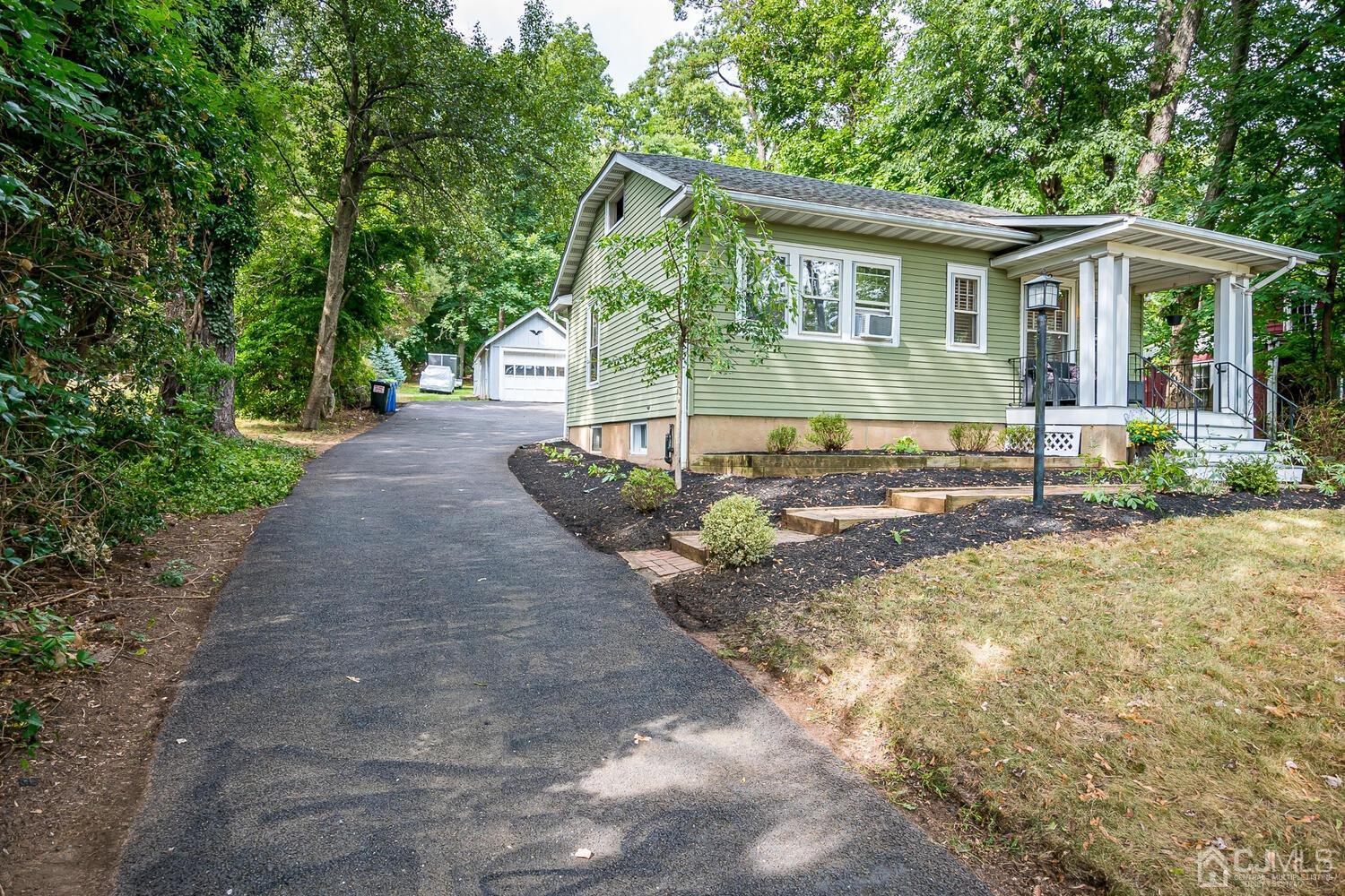 2015 Washington Valley Road Bridgewater, NJ 08836 - Photo 1 of 46 a front view of a house with a yard and potted plants