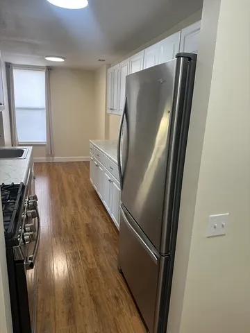 a kitchen with metallic refrigerator and window