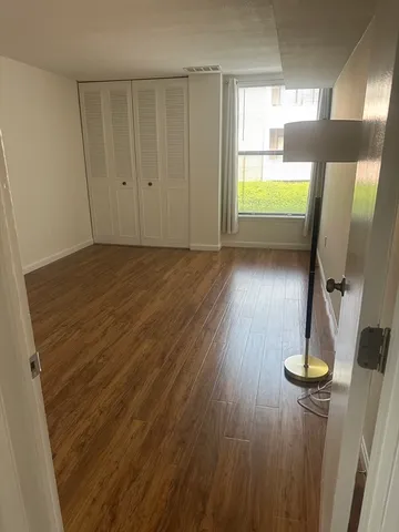 a view of room with wooden floor