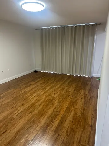 a view of room with wooden floor