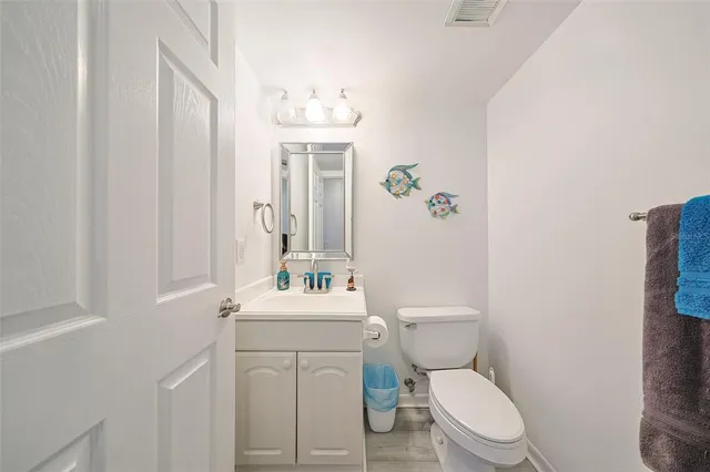 a white toilet sitting next to a bathroom sink