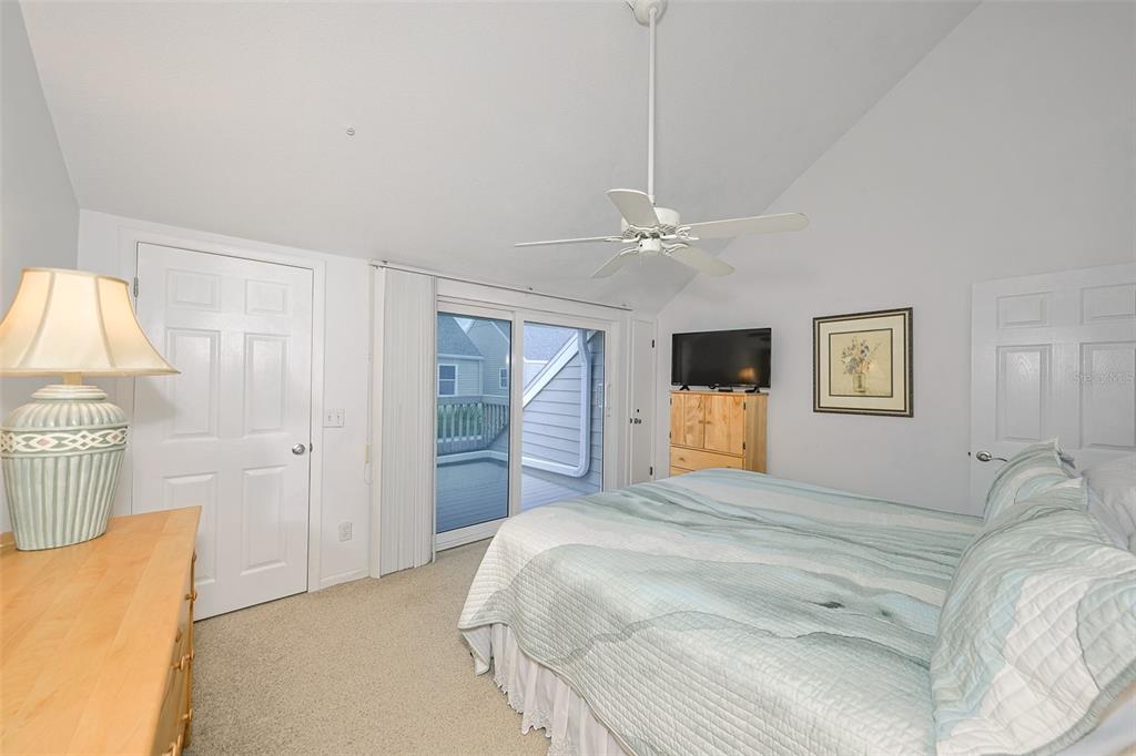 19930 Gulf Boulevard, Unit 1B Indian Shores, FL 33785 - Photo 17 of 26 a bedroom with a bed and a chandelier