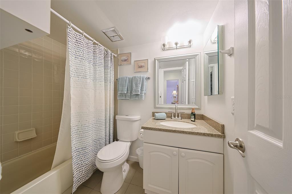 19930 Gulf Boulevard, Unit 1B Indian Shores, FL 33785 - Photo 20 of 26 a bathroom with a sink a toilet and shower