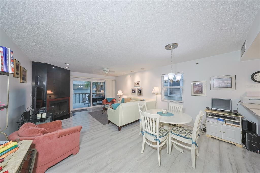 19930 Gulf Boulevard, Unit 1B Indian Shores, FL 33785 - Photo 2 of 26 a living room with fireplace furniture and a wooden floor