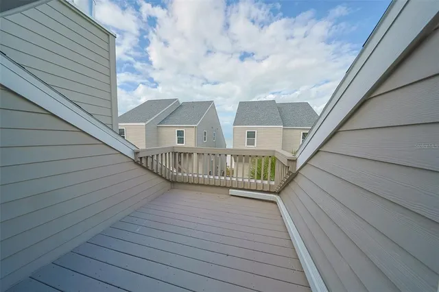 a view of balcony with wooden floor