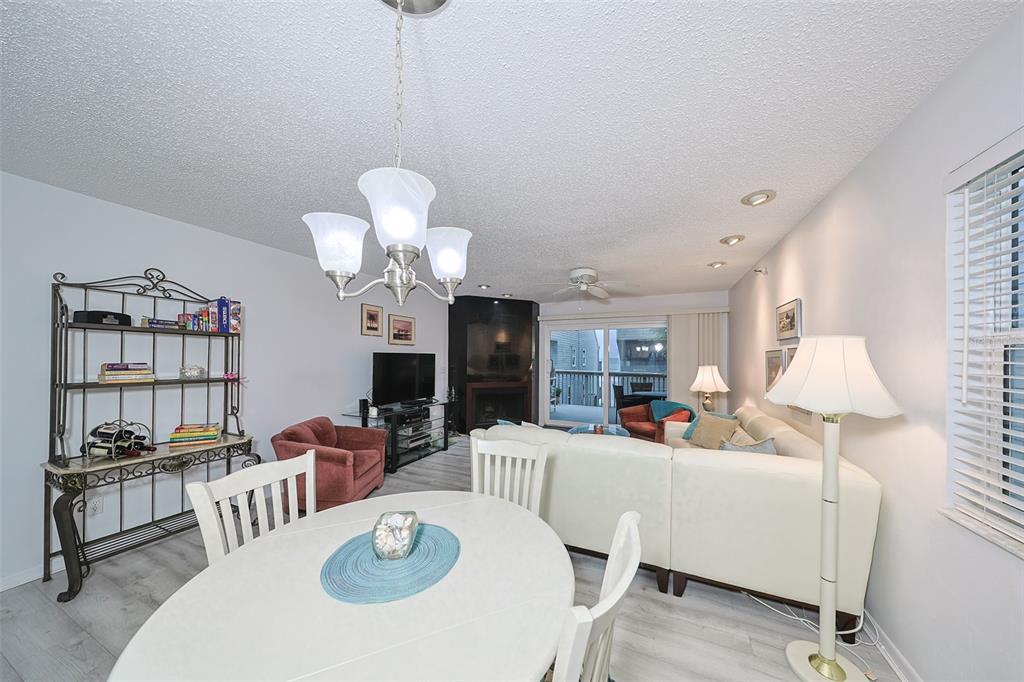 19930 Gulf Boulevard, Unit 1B Indian Shores, FL 33785 - Photo 3 of 26 a living room with furniture a chandelier and a dining room