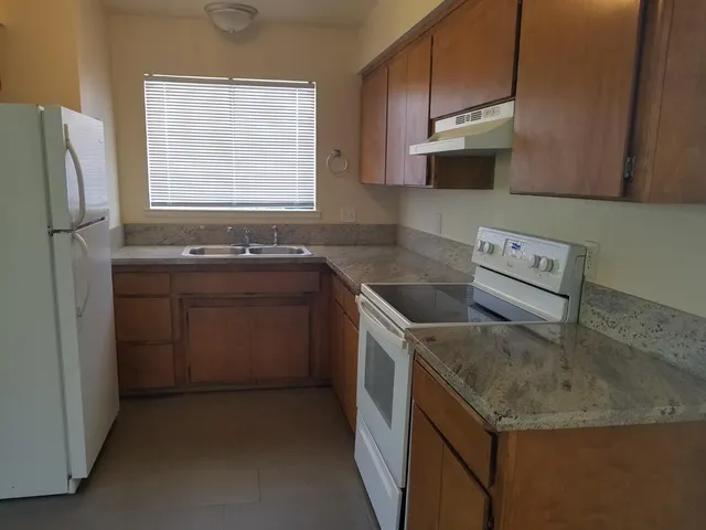 a utility room with cabinets washer and dryer