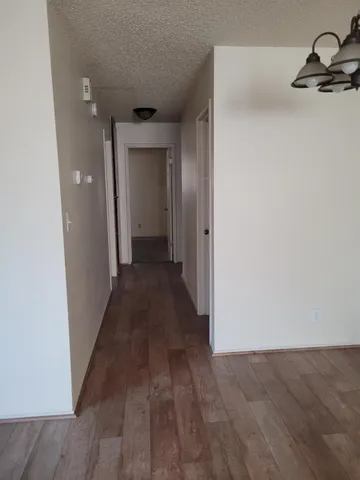 a view of a hallway with wooden floor