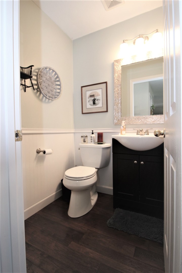 1409 Hull Street Normal, IL 61761 - Photo 11 of 29 a bathroom with a toilet sink and mirror