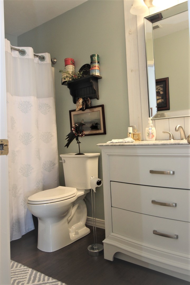 1409 Hull Street Normal, IL 61761 - Photo 18 of 29 a bathroom with a toilet sink and mirror