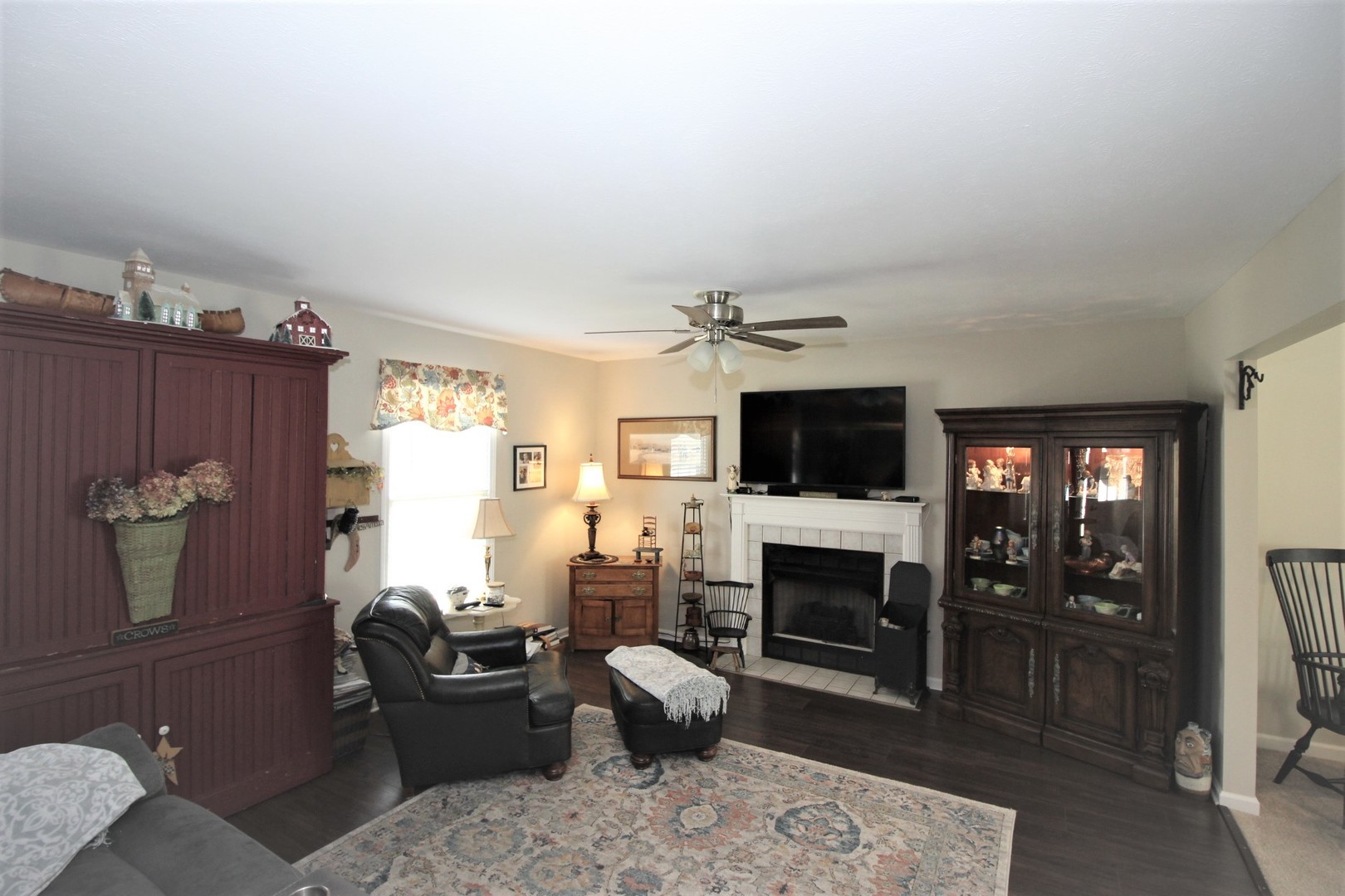 1409 Hull Street Normal, IL 61761 - Photo 8 of 29 a living room with furniture a flat screen tv and a fireplace