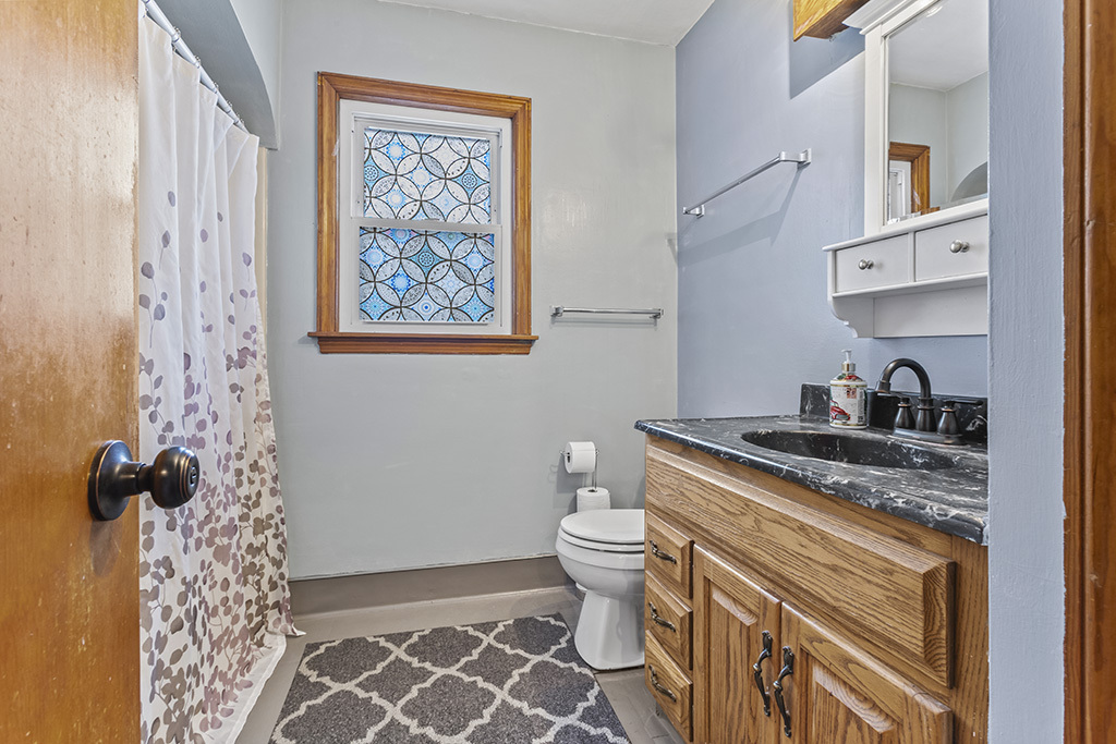 818 East 11th Street Lockport, IL 60441 - Photo 11 of 13 a bathroom with a granite countertop sink and a toilet
