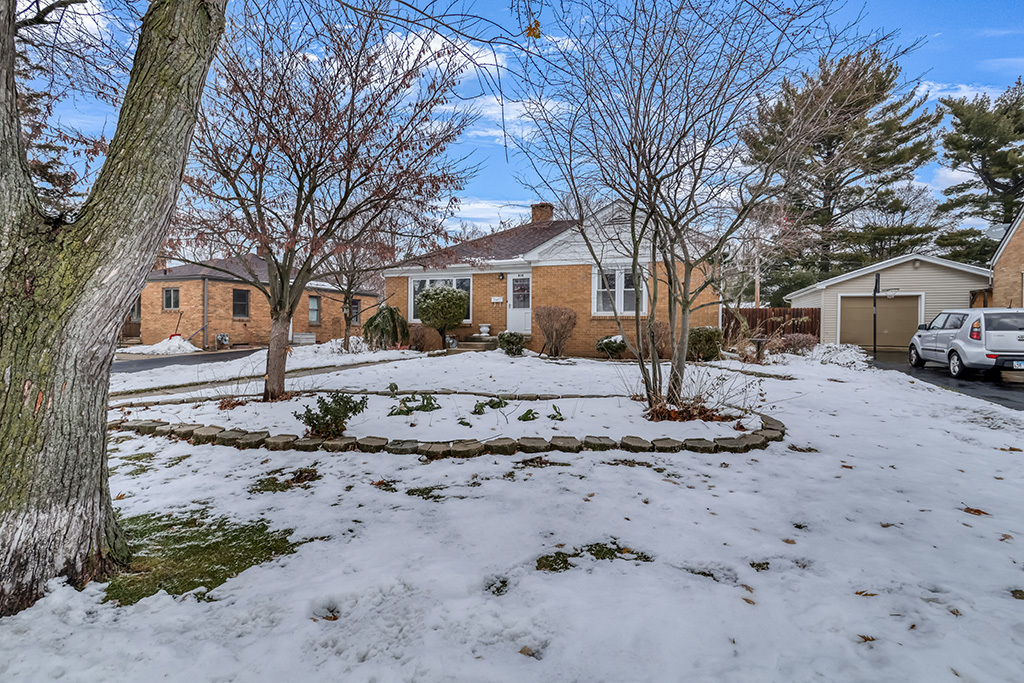 818 East 11th Street Lockport, IL 60441 - Photo 2 of 13 a front view of a house with a yard covered in snow