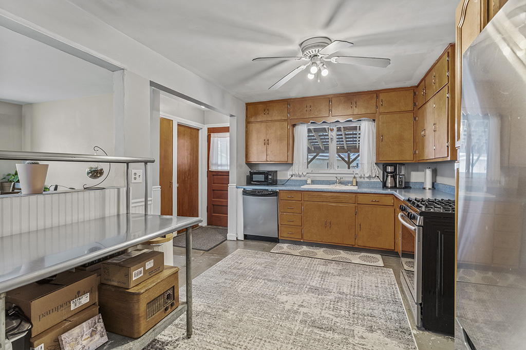 818 East 11th Street Lockport, IL 60441 - Photo 8 of 13 a kitchen with stainless steel appliances granite countertop a stove a sink and a refrigerator