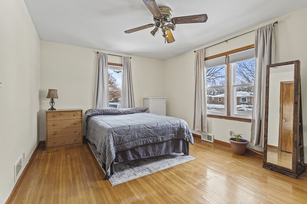 818 East 11th Street Lockport, IL 60441 - Photo 9 of 13 a spacious bedroom with a bed and a window