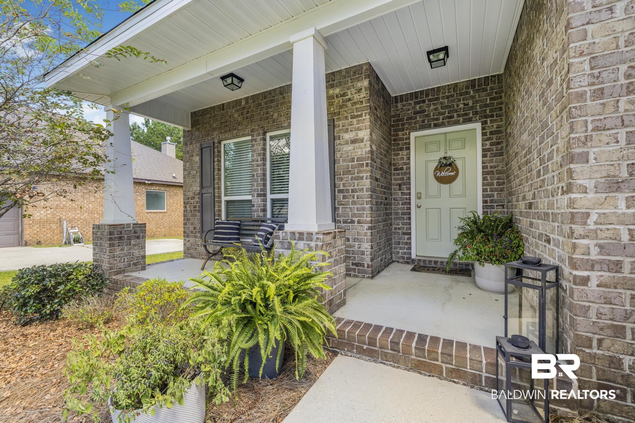 31336 Hoot Owl Road Daphne, AL 36527 - Photo 26 of 36 Property entrance with covered porch and brick siding