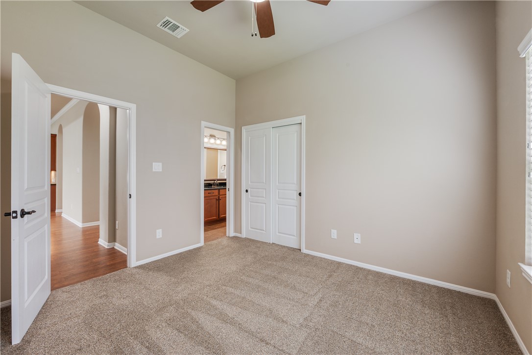 3085 Archer Circle Bryan, TX 77808 - Photo 18 of 31 an empty room with ceiling fan and entryway