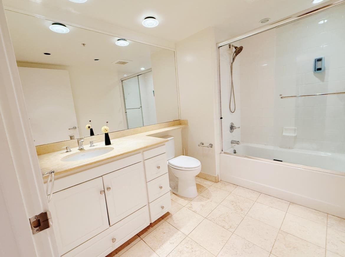 400 Beale Street, Unit 1102 San Francisco, CA 94105 - Photo 12 of 26 a bathroom with a double vanity sink toilet mirror and shower