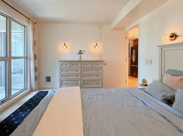 a bedroom with a bed and a dresser