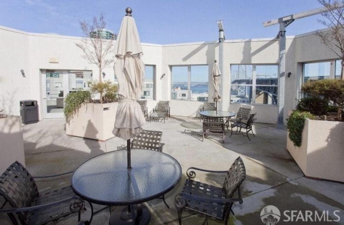400 Beale Street, Unit 1102 San Francisco, CA 94105 - Photo 24 of 26 a living room with couches a coffee table and a chandelier