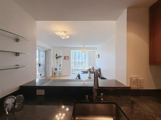 a room with a table chairs and a window