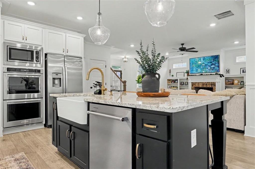 943 Clubside Drive Monroe, GA 30655 - Photo 76 of 93 a kitchen with stainless steel appliances granite countertop a kitchen island a stove and a sink