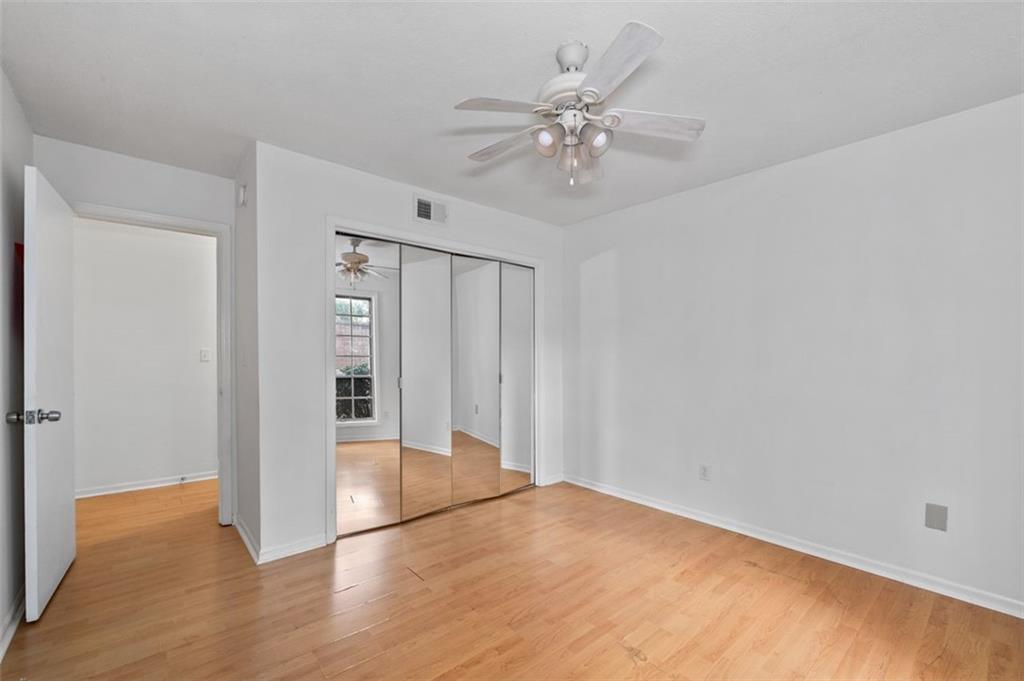 6851 Roswell Road, Unit D28 Atlanta, GA 30328 - Photo 20 of 28 a view of an empty room with wooden floor