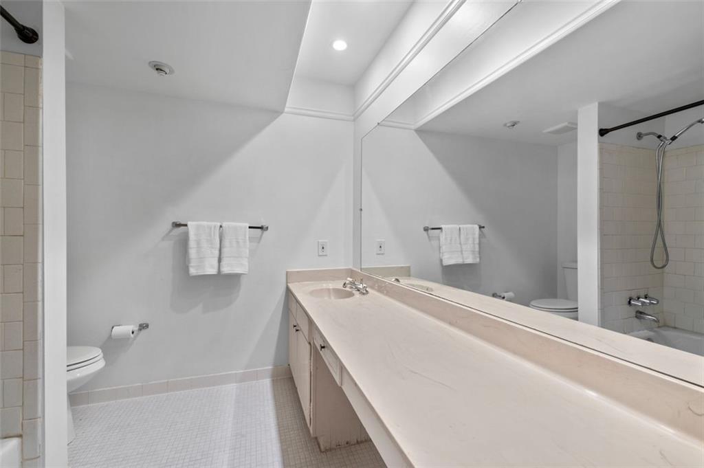 6851 Roswell Road, Unit D28 Atlanta, GA 30328 - Photo 21 of 28 a bathroom with a tub sink and mirror