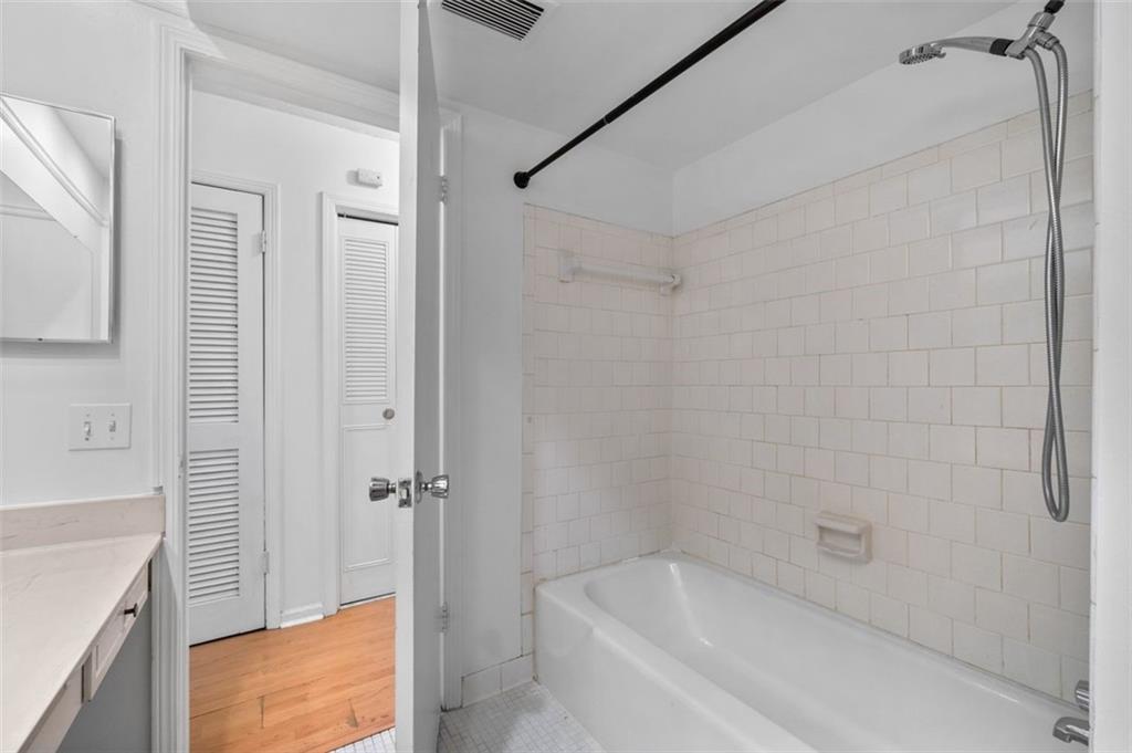 6851 Roswell Road, Unit D28 Atlanta, GA 30328 - Photo 22 of 28 a bathroom with a bathtub and shower