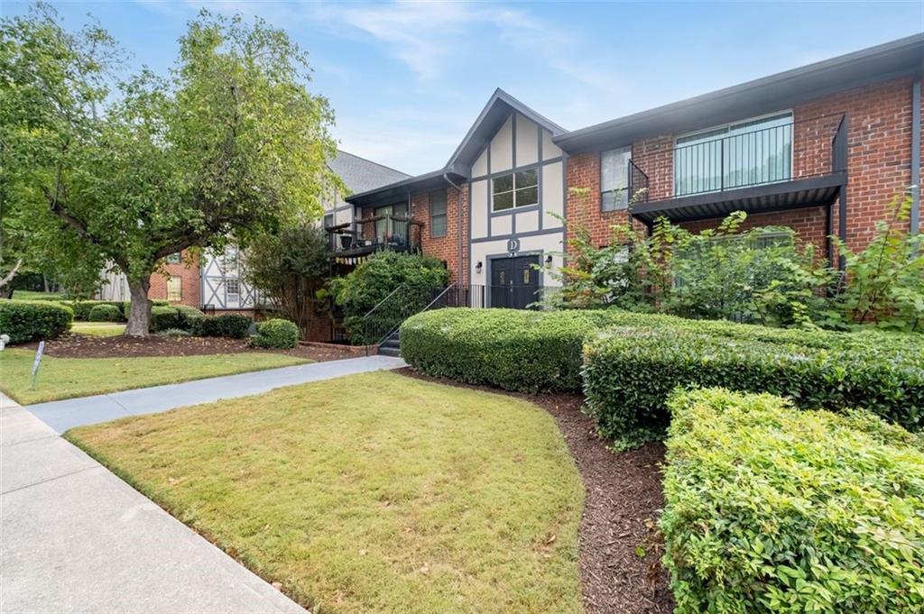 6851 Roswell Road, Unit D28 Atlanta, GA 30328 - Photo 27 of 28 a view of a house with a yard and potted plants