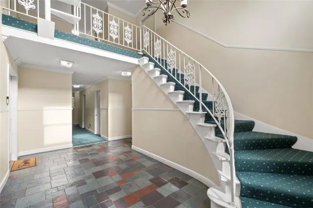 a view of entryway and hall with wooden floor