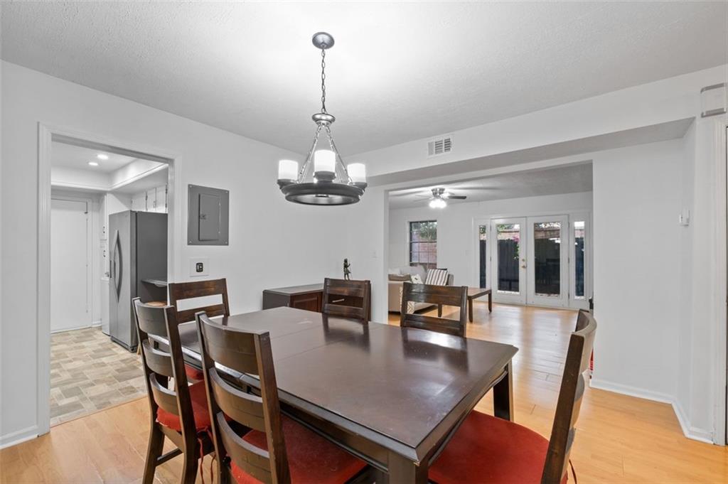 6851 Roswell Road, Unit D28 Atlanta, GA 30328 - Photo 9 of 28 a view of a dining room with furniture a chandelier and wooden floor