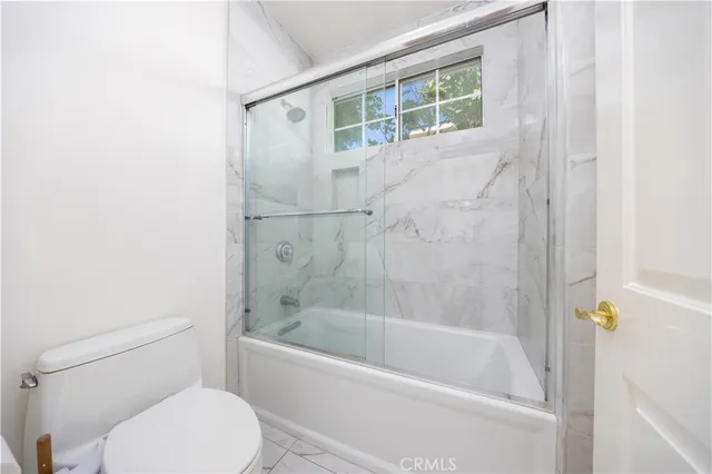 a white bath tub sitting next to a toilet